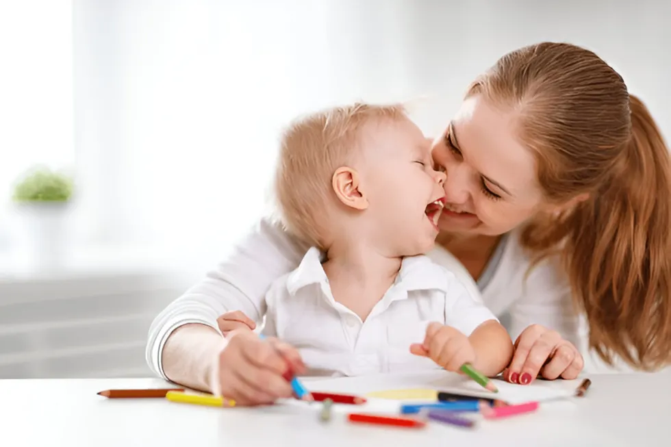 A Teacher and a Child having fun while drawing